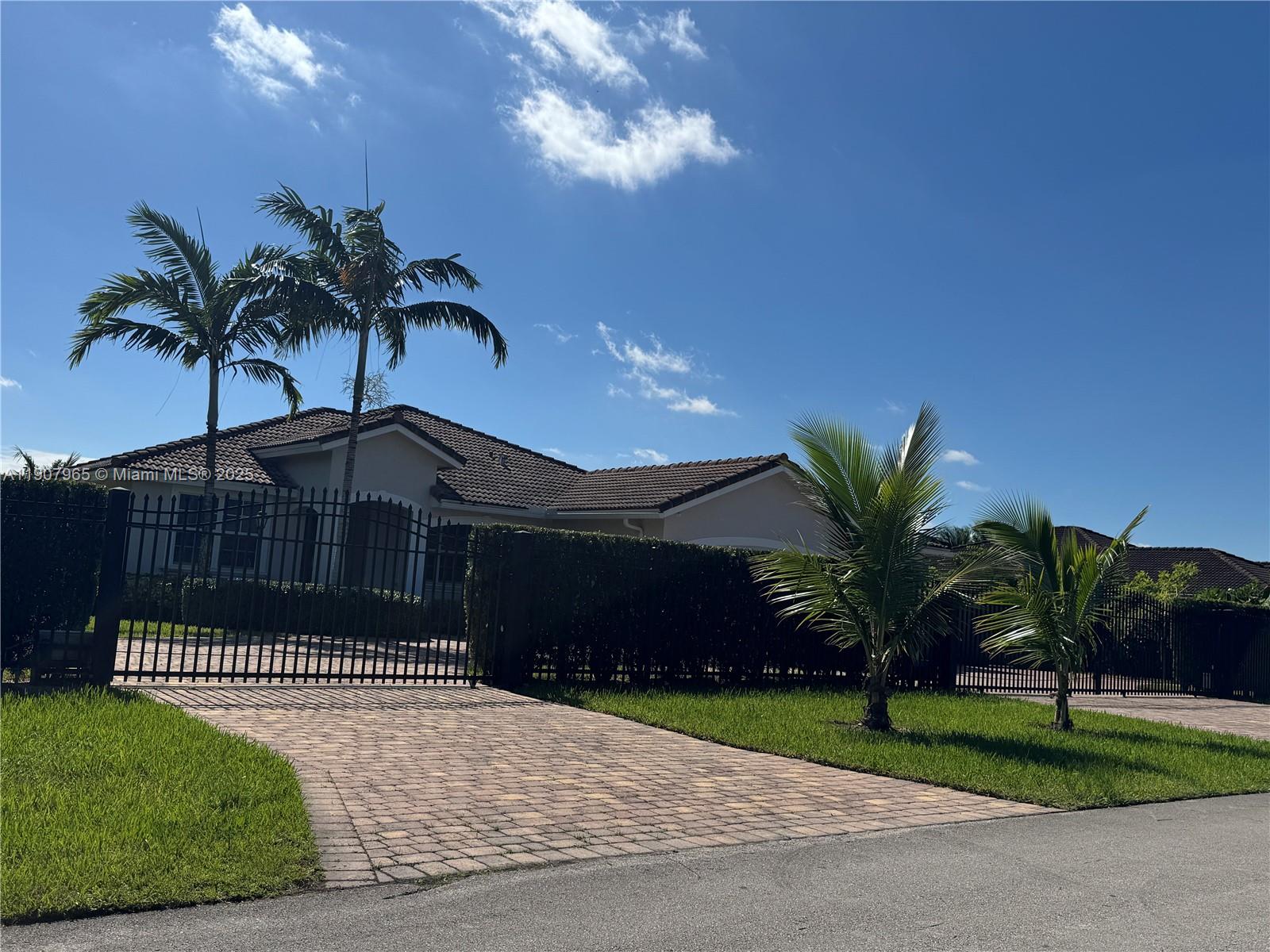 12800 Southwest 222nd Street Miami, FL 33170 - Photo 3 of 19 a front view of a house having yard