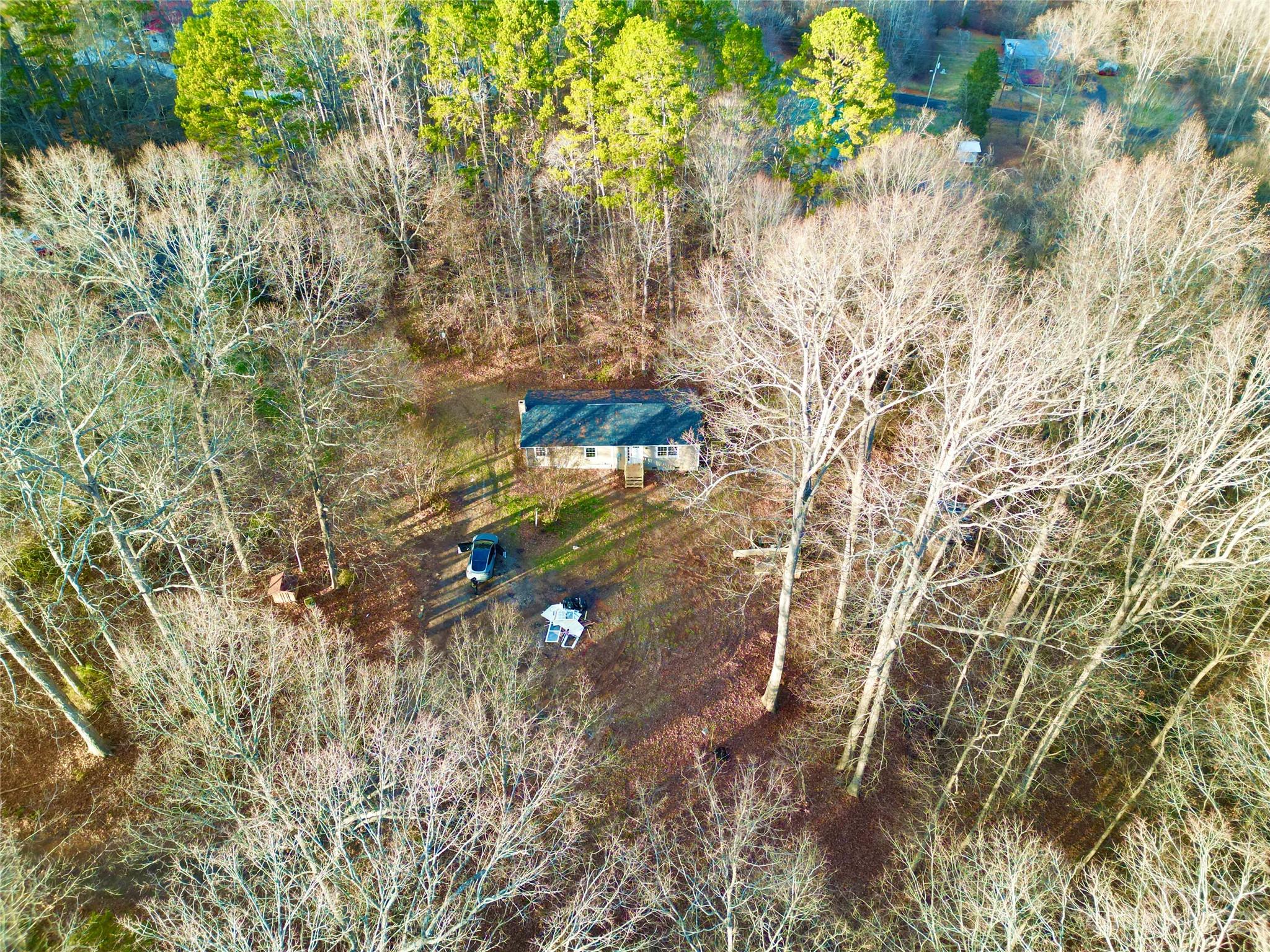 285 Arrowood Road Salisbury, NC 28144 - Photo 14 of 15 a backyard of a house with lots of green space and fog