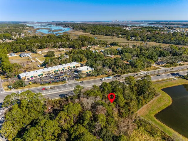 an aerial view of a houses with a lake