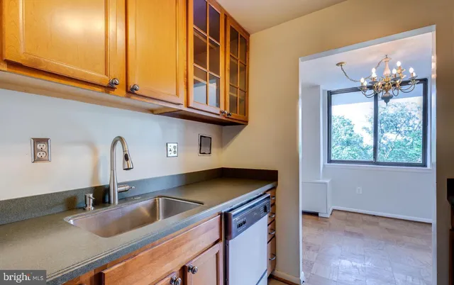 a kitchen with granite countertop a sink a stove and a microwave oven