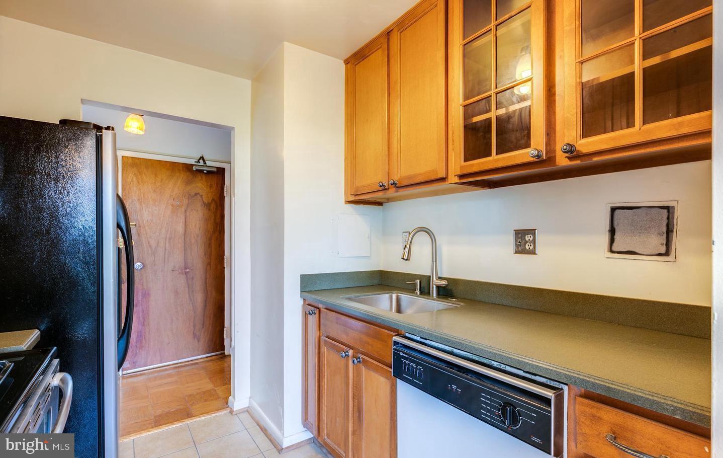 4401 Cherry Hill Road, Unit 66 Arlington, VA 22207 - Photo 13 of 29 a kitchen with stainless steel appliances granite countertop a sink and a refrigerator