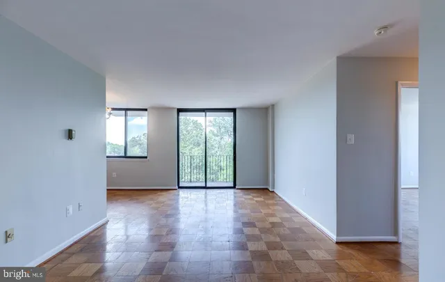 a view of an empty room with glass door