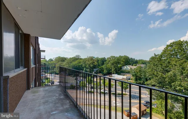 a balcony with trees in front of it