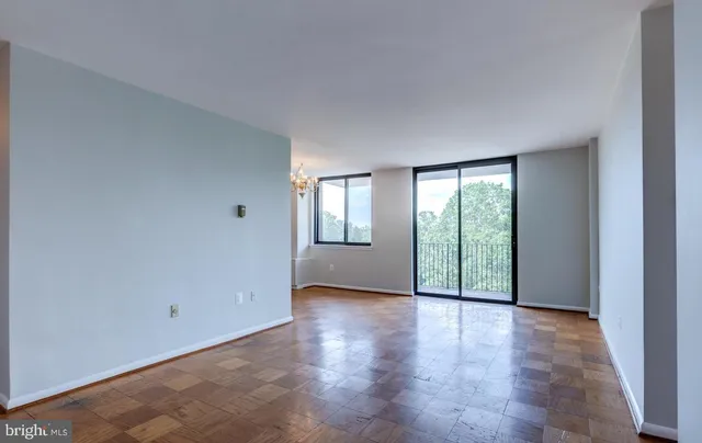 a view of an empty room with glass door and balcony