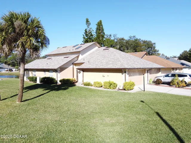 a house with green field in front of it