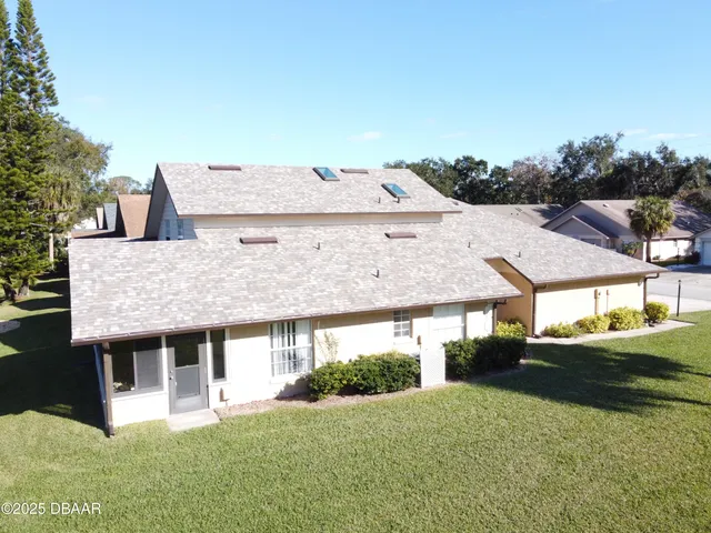 a front view of house with yard and garage