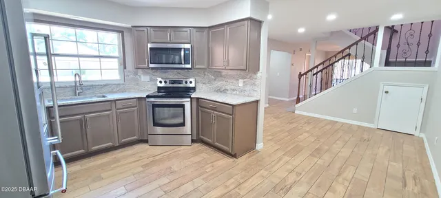 a kitchen with a sink stove and cabinets