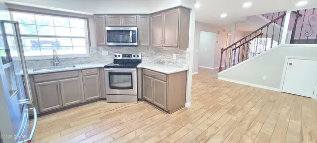 a kitchen with a sink stove and cabinets