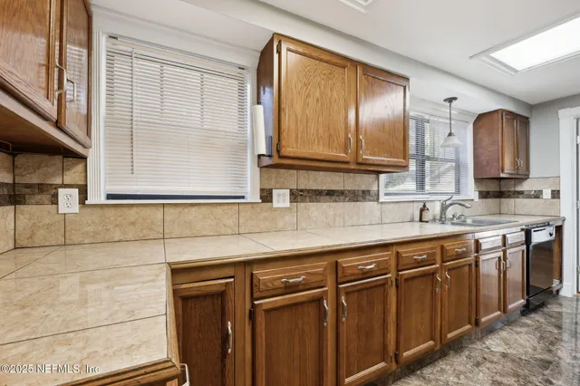 a kitchen with stainless steel appliances granite countertop cabinets and window