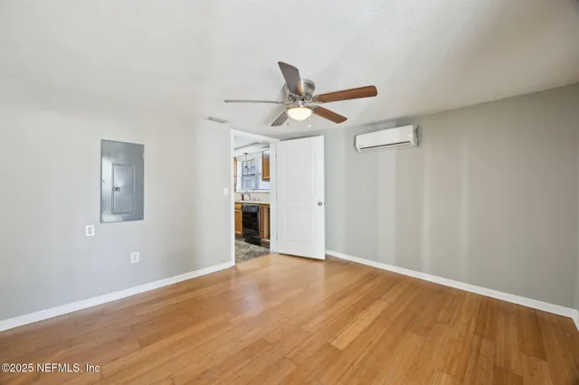 a view of a livingroom with wooden floor and a ceiling fan