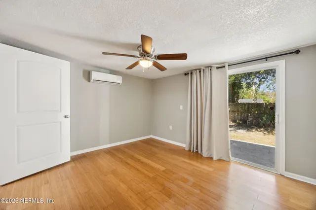 a view of a livingroom with a ceiling fan and window