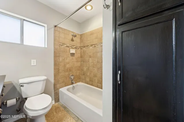a white toilet sitting next to a bathroom sink