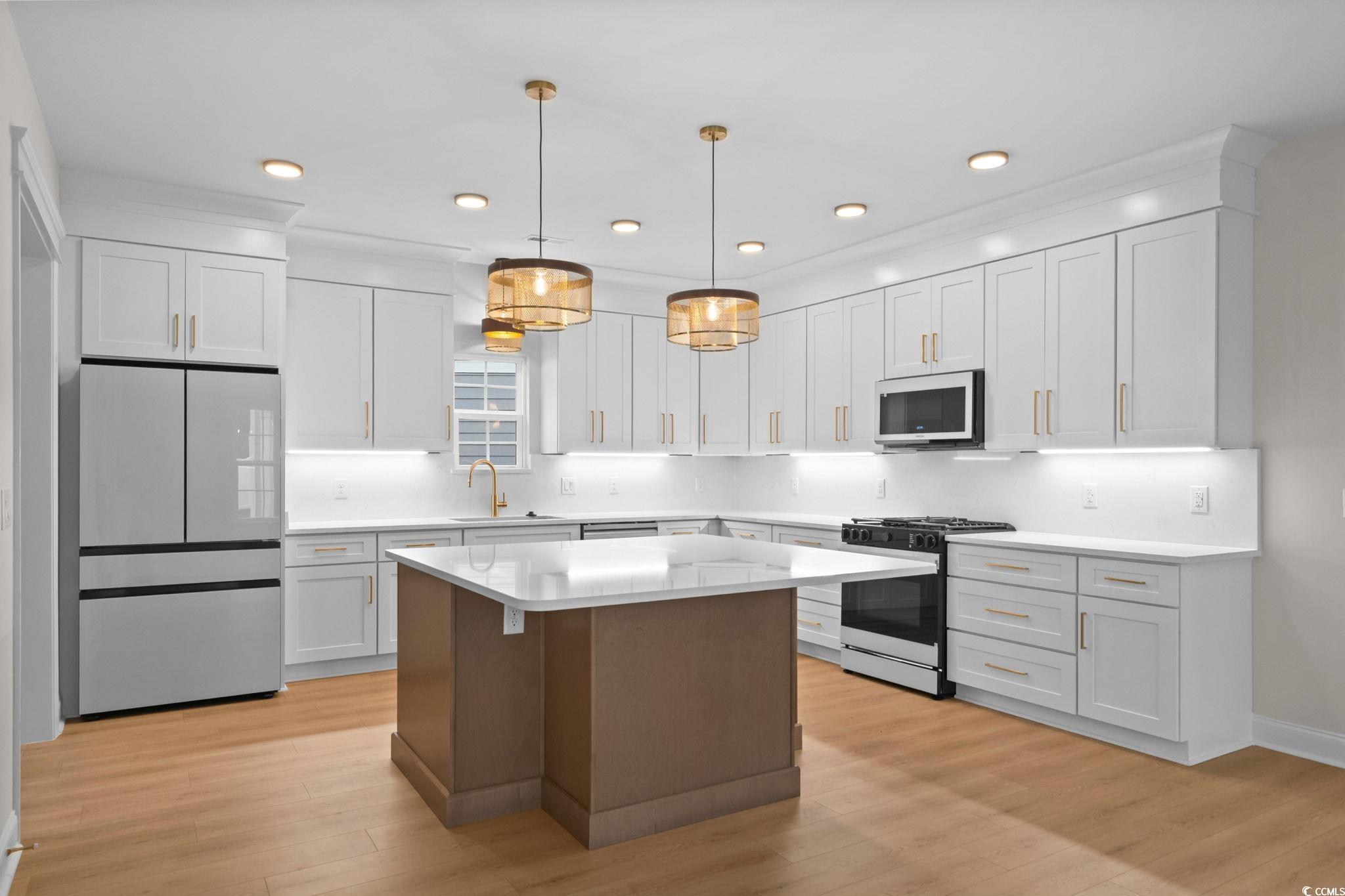 148 Arbor Ridge Circle Conway, SC 29526 - Photo 12 of 37 Kitchen with freestanding refrigerator, range with gas stovetop, white cabinets, pendant lighting, and recessed lighting
