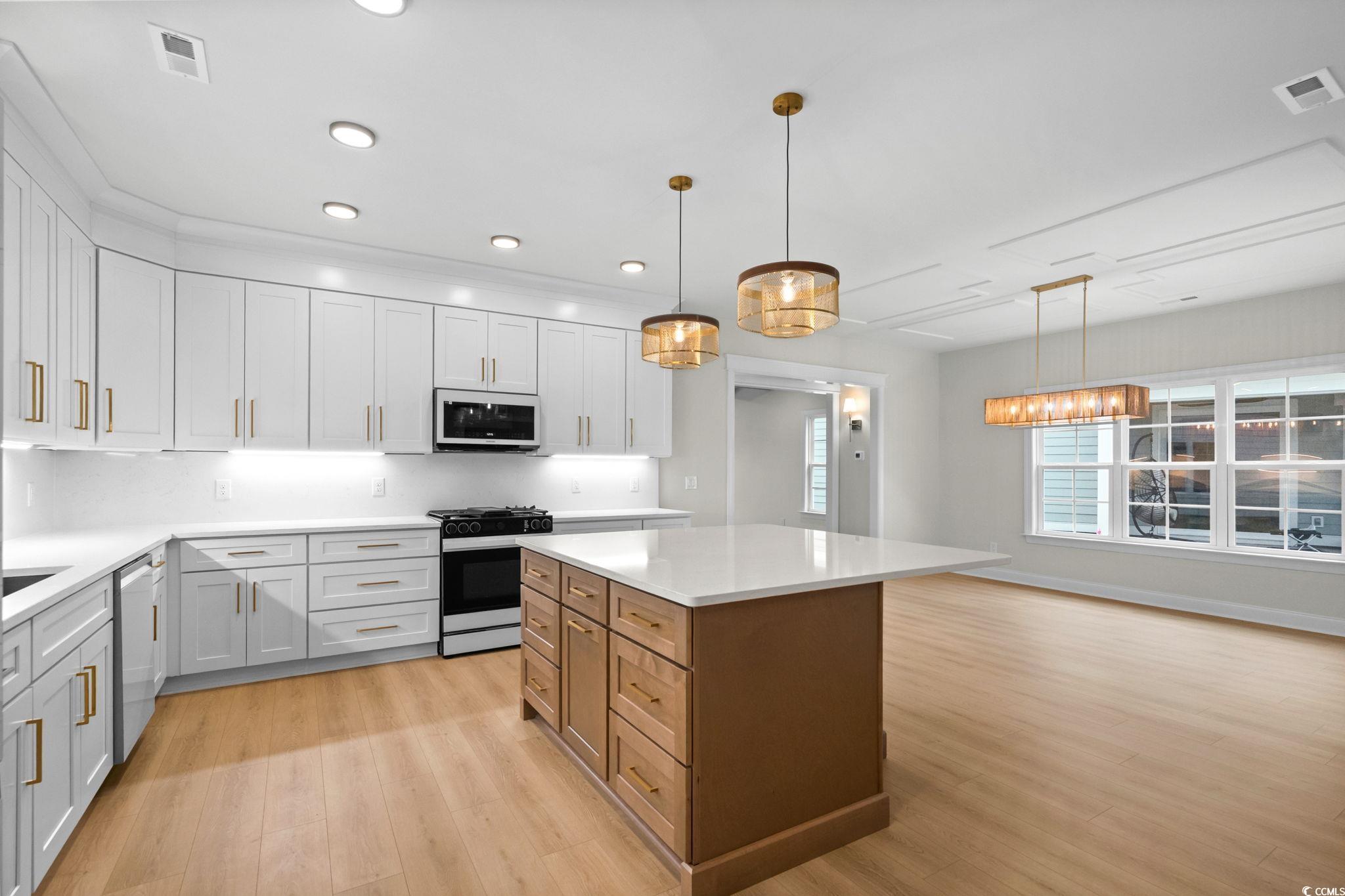 148 Arbor Ridge Circle Conway, SC 29526 - Photo 14 of 37 Kitchen with range with gas stovetop, decorative light fixtures, light wood-style floors, a kitchen island, and recessed lighting