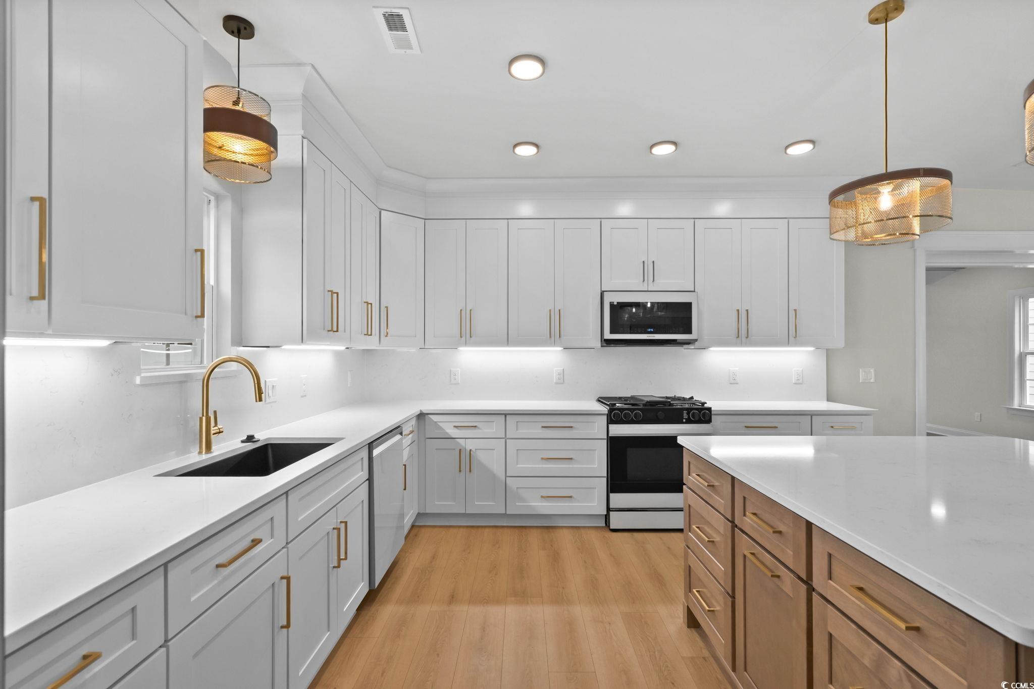 148 Arbor Ridge Circle Conway, SC 29526 - Photo 16 of 37 Kitchen featuring pendant lighting, white cabinets, range with gas stovetop, light stone countertops, and recessed lighting