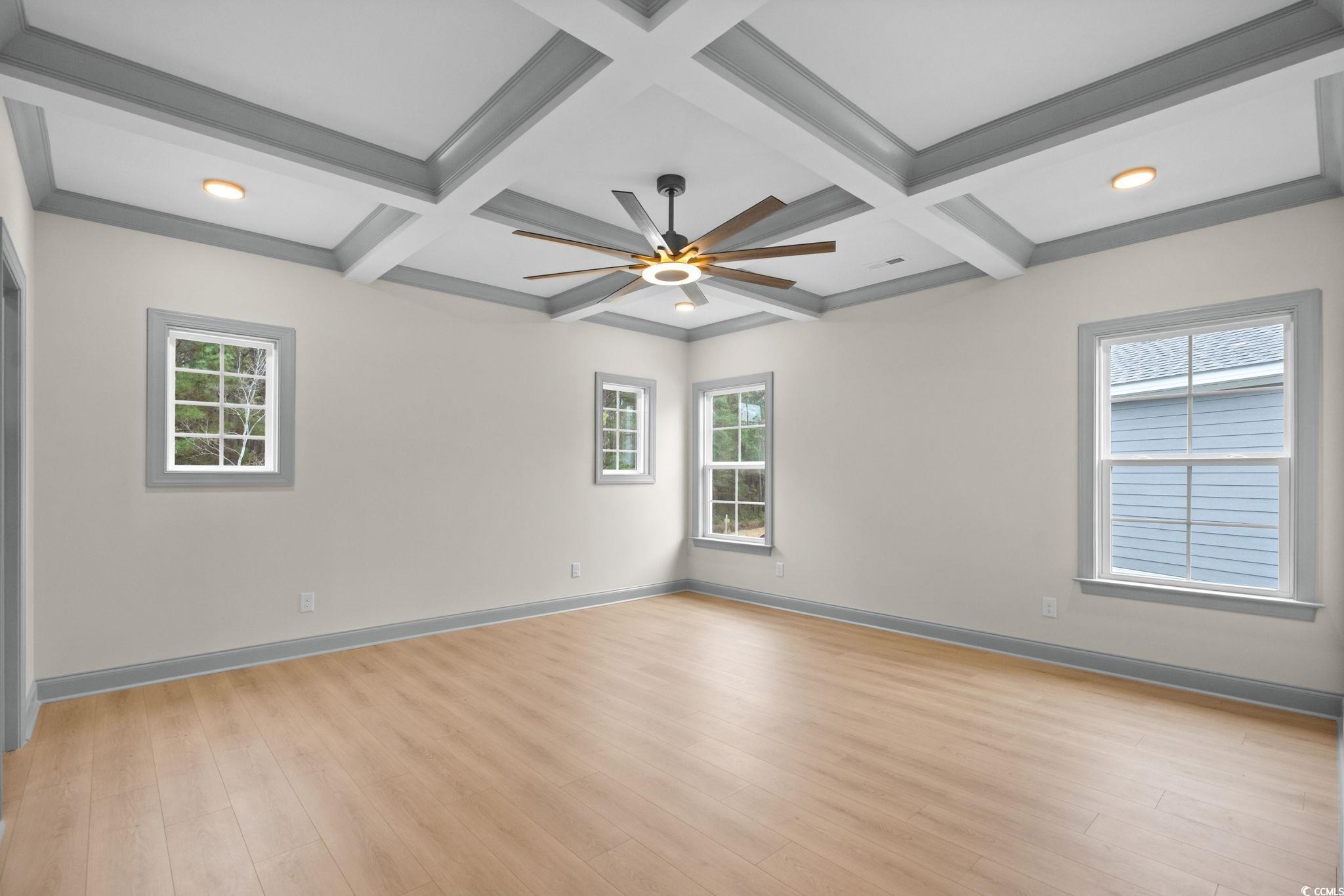 148 Arbor Ridge Circle Conway, SC 29526 - Photo 25 of 37 Unfurnished room with coffered ceiling, light wood-type flooring, healthy amount of natural light, beam ceiling, and ceiling fan