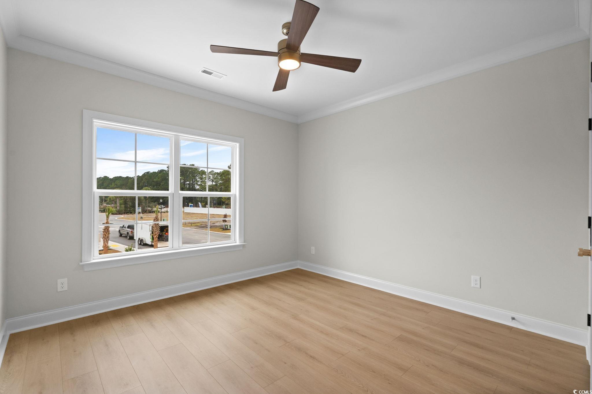 148 Arbor Ridge Circle Conway, SC 29526 - Photo 31 of 37 Spare room featuring crown molding, light wood-type flooring, and ceiling fan
