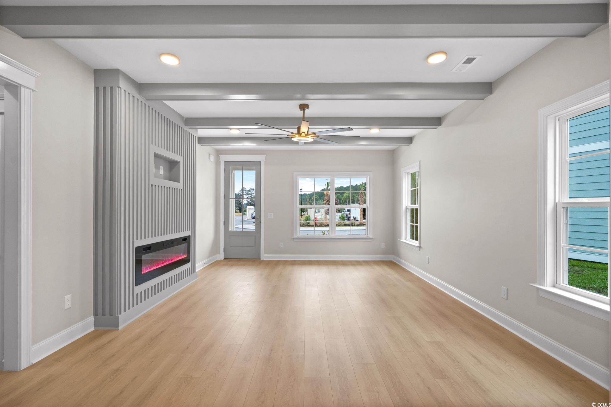 148 Arbor Ridge Circle Conway, SC 29526 - Photo 5 of 37 Unfurnished living room featuring recessed lighting, beamed ceiling, ceiling fan, light wood-style flooring, and a glass covered fireplace