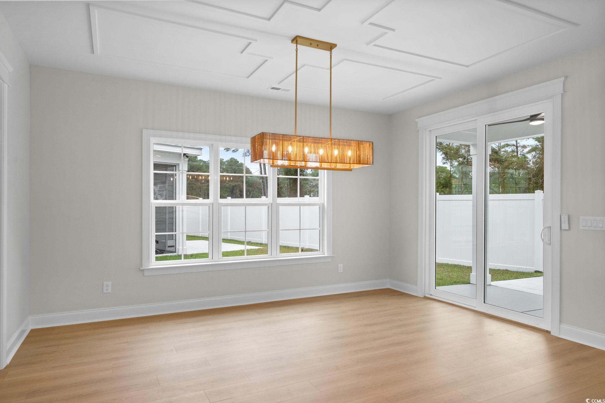 148 Arbor Ridge Circle Conway, SC 29526 - Photo 10 of 37 Unfurnished dining area featuring light wood finished floors and a chandelier