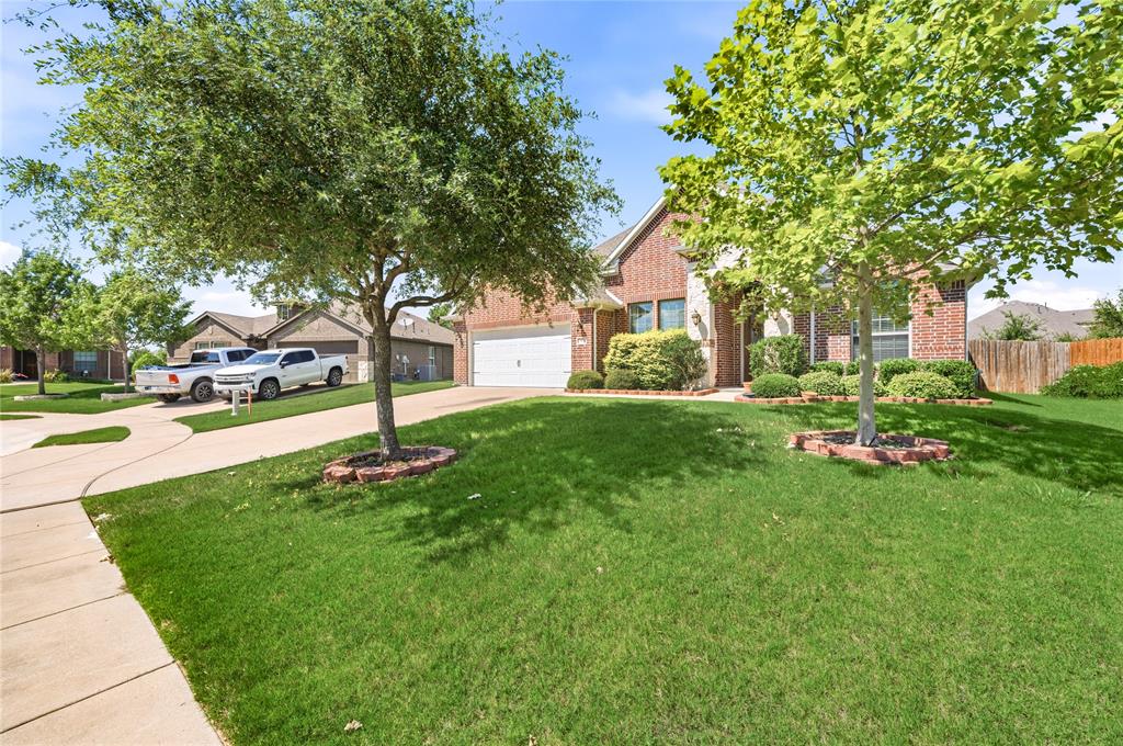 140 Chestnut Road Waxahachie, TX 75165 - Photo 3 of 26 Brick facade residence featuring an attached two-car garage