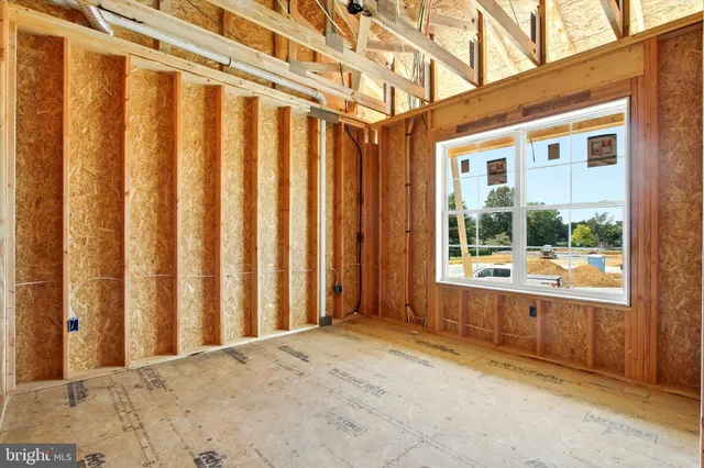 a view of a porch with wooden floor and a window