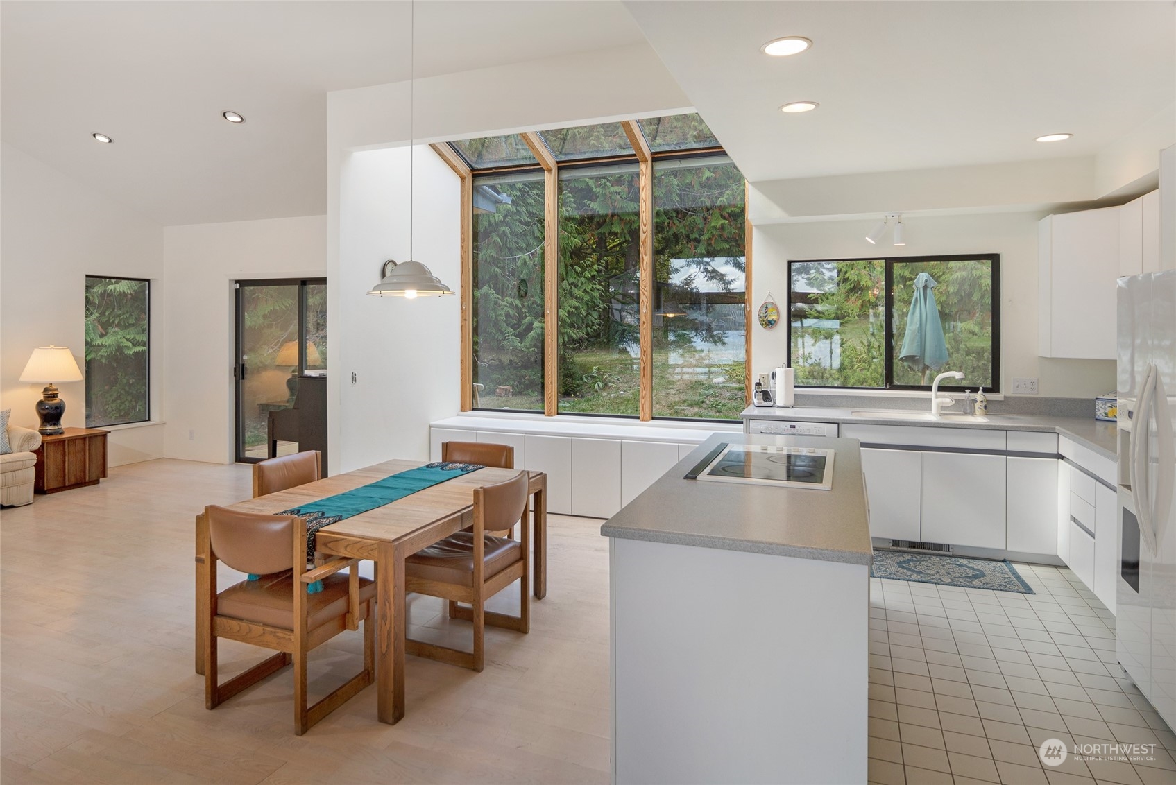 1045 Port Stanley Road Lopez Island, WA 98261 - Photo 13 of 40 a kitchen with a table chairs sink and cabinets