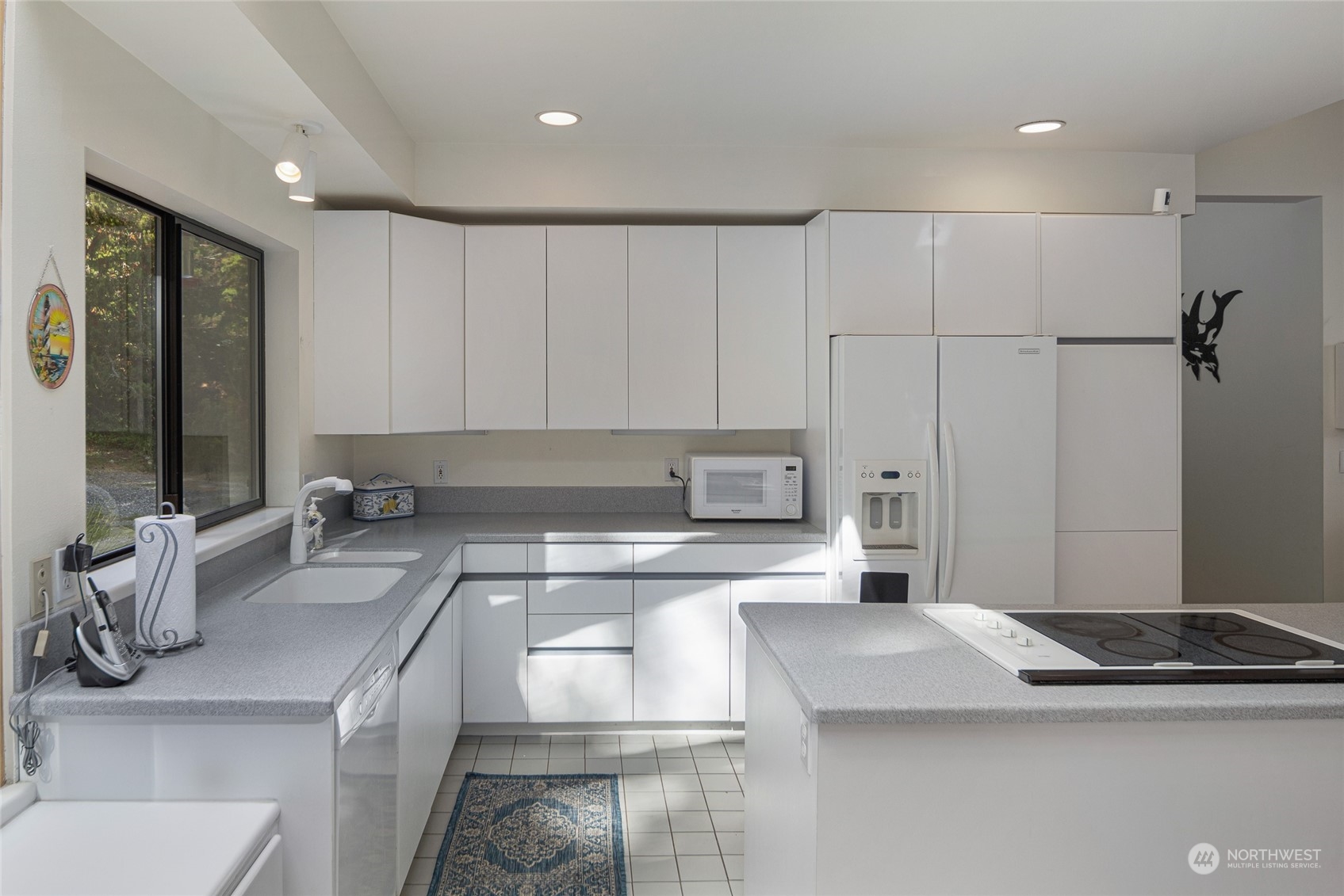 1045 Port Stanley Road Lopez Island, WA 98261 - Photo 14 of 40 a kitchen with stainless steel appliances granite countertop a sink stove and cabinets