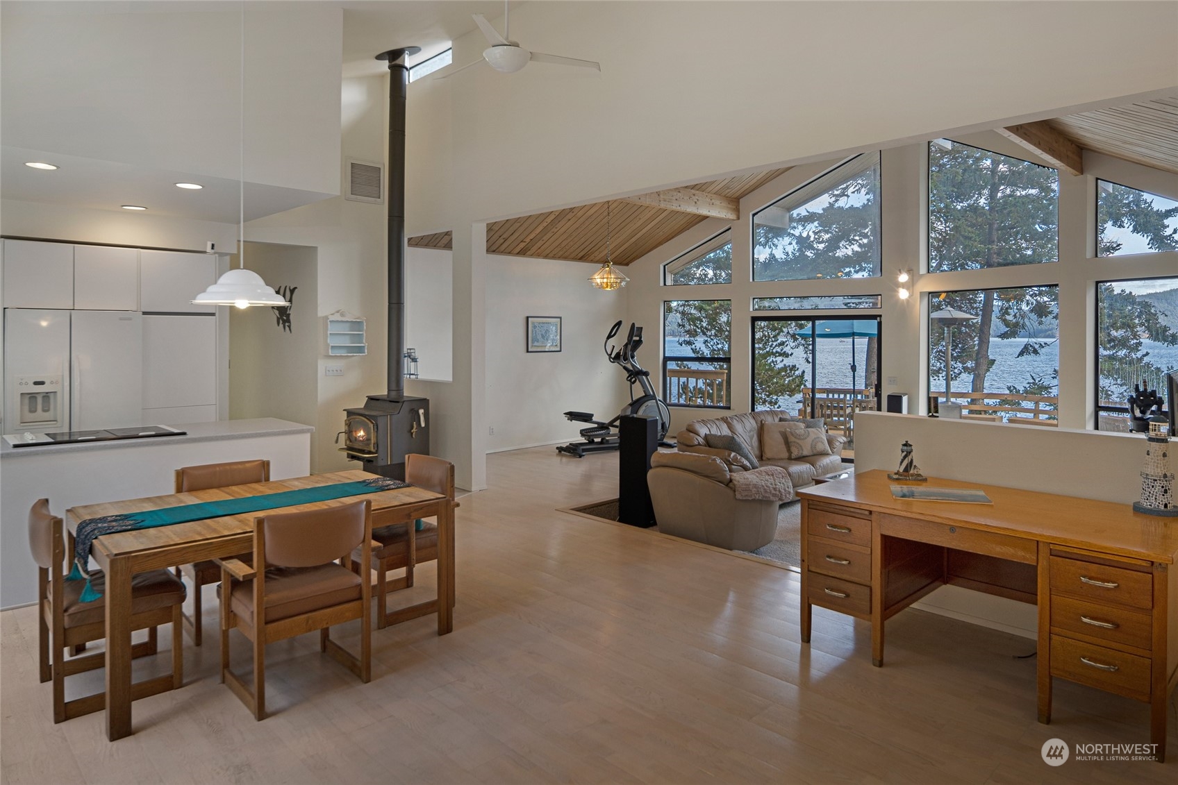1045 Port Stanley Road Lopez Island, WA 98261 - Photo 16 of 40 a room with furniture a large window and a chandelier