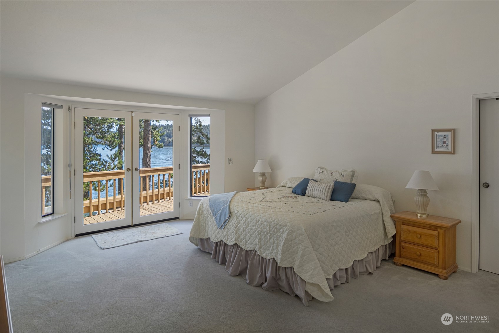 1045 Port Stanley Road Lopez Island, WA 98261 - Photo 20 of 40 a spacious bedroom with a bed and a large window