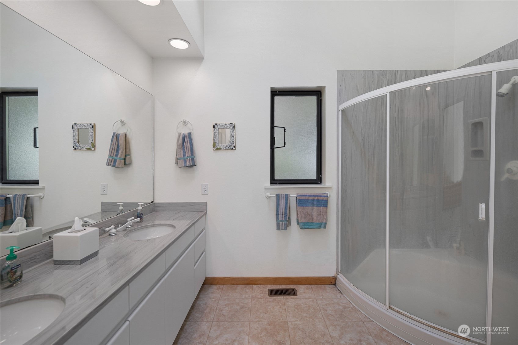 1045 Port Stanley Road Lopez Island, WA 98261 - Photo 22 of 40 a bathroom with a granite countertop sink a mirror and shower