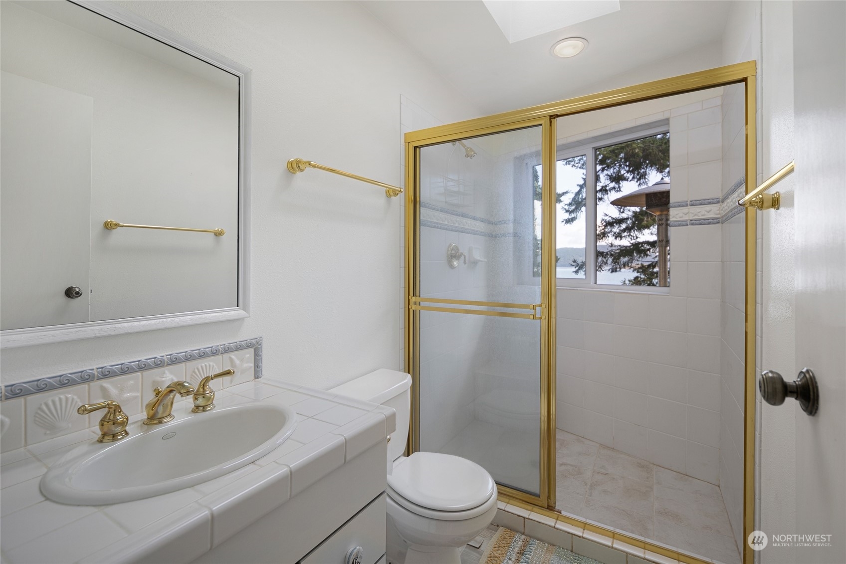 1045 Port Stanley Road Lopez Island, WA 98261 - Photo 25 of 40 a bathroom with a sink a toilet and shower