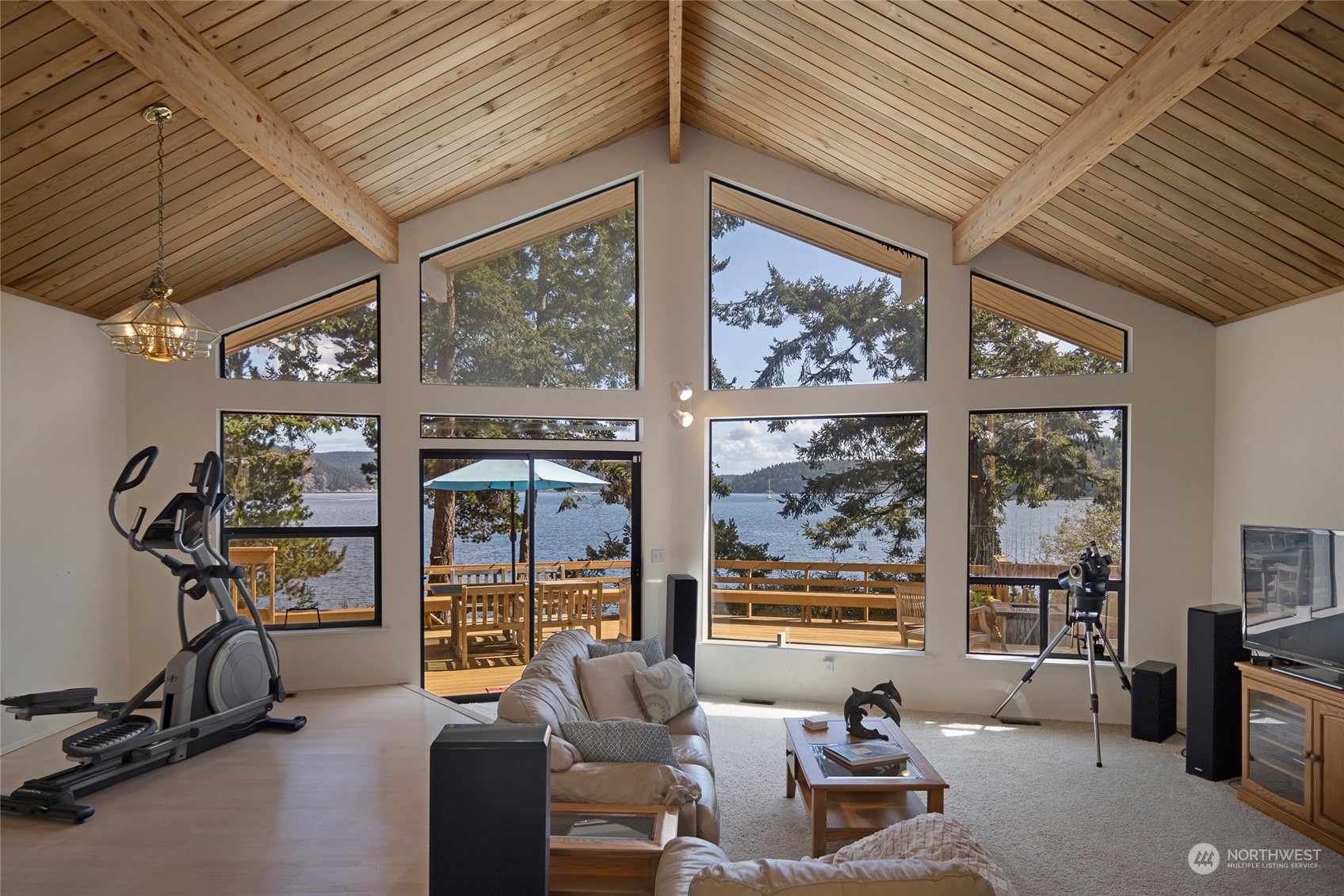 1045 Port Stanley Road Lopez Island, WA 98261 - Photo 7 of 40 a living room with furniture a flat screen tv and windows
