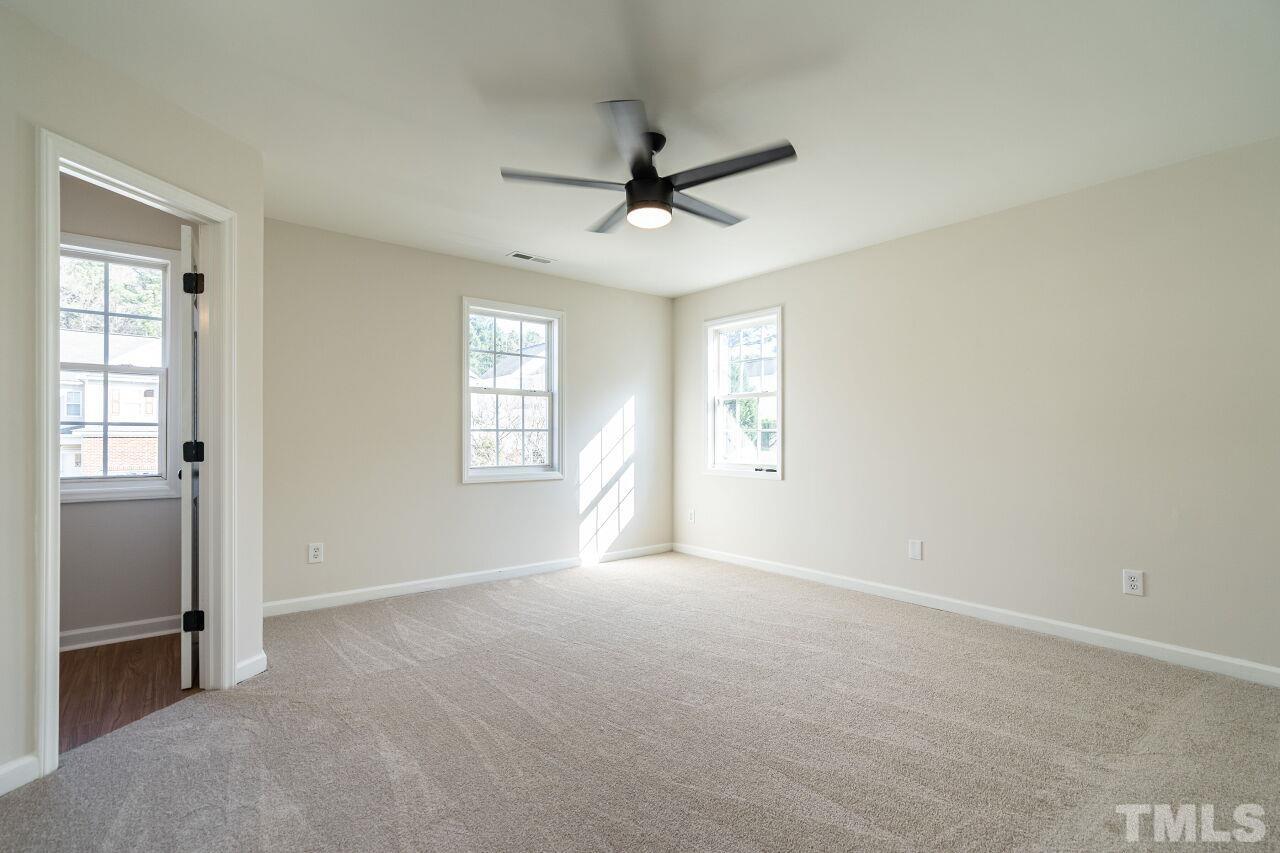 4204 Beacon Crest Way Raleigh, NC 27604 - Photo 19 of 29 an empty room with windows and fan