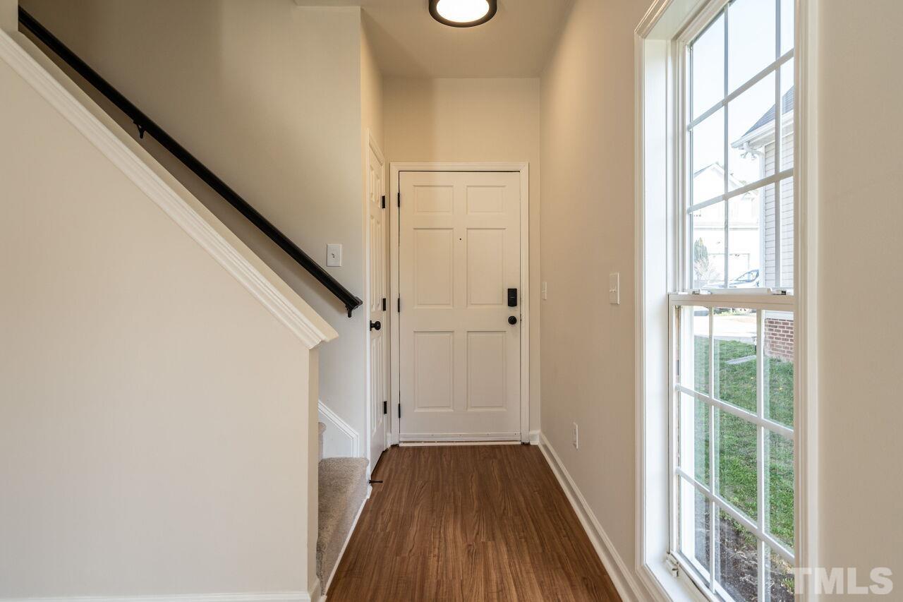 4204 Beacon Crest Way Raleigh, NC 27604 - Photo 4 of 29 a view of a hallway with wooden floor and staircase
