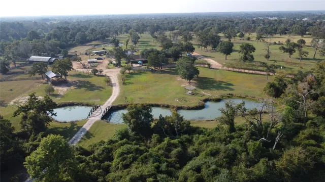an aerial view of a house with a yard