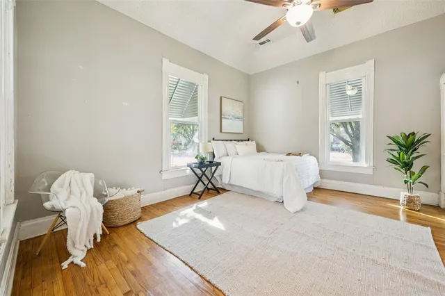 a spacious bedroom with a bed and a potted plant