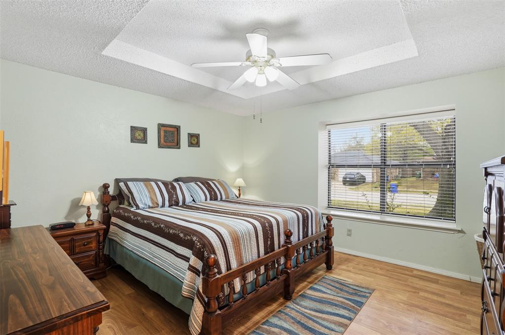6437 High Lawn Terrace Watauga, TX 76148 - Photo 13 of 21 a bedroom with a bed lamp and window