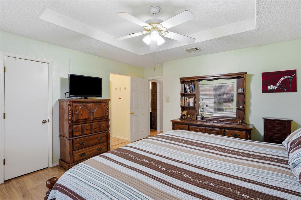 6437 High Lawn Terrace Watauga, TX 76148 - Photo 14 of 21 a bedroom with a bed and a flat screen tv