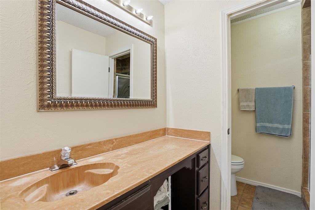 6437 High Lawn Terrace Watauga, TX 76148 - Photo 15 of 21 a bathroom with a sink and a mirror