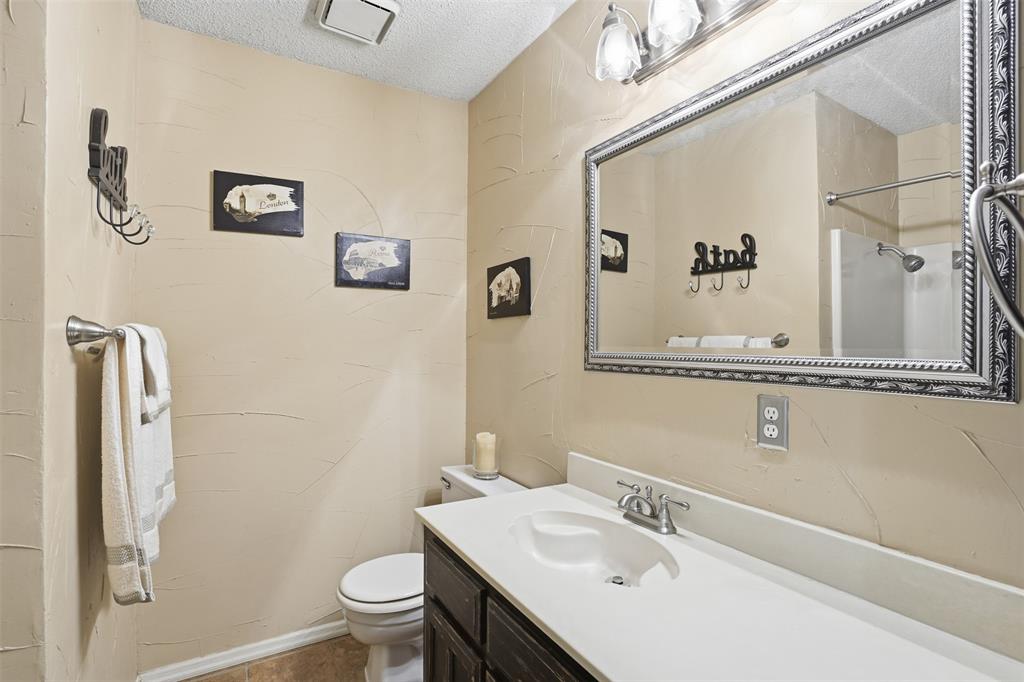 6437 High Lawn Terrace Watauga, TX 76148 - Photo 17 of 21 a bathroom with a sink vanity mirror and toilet