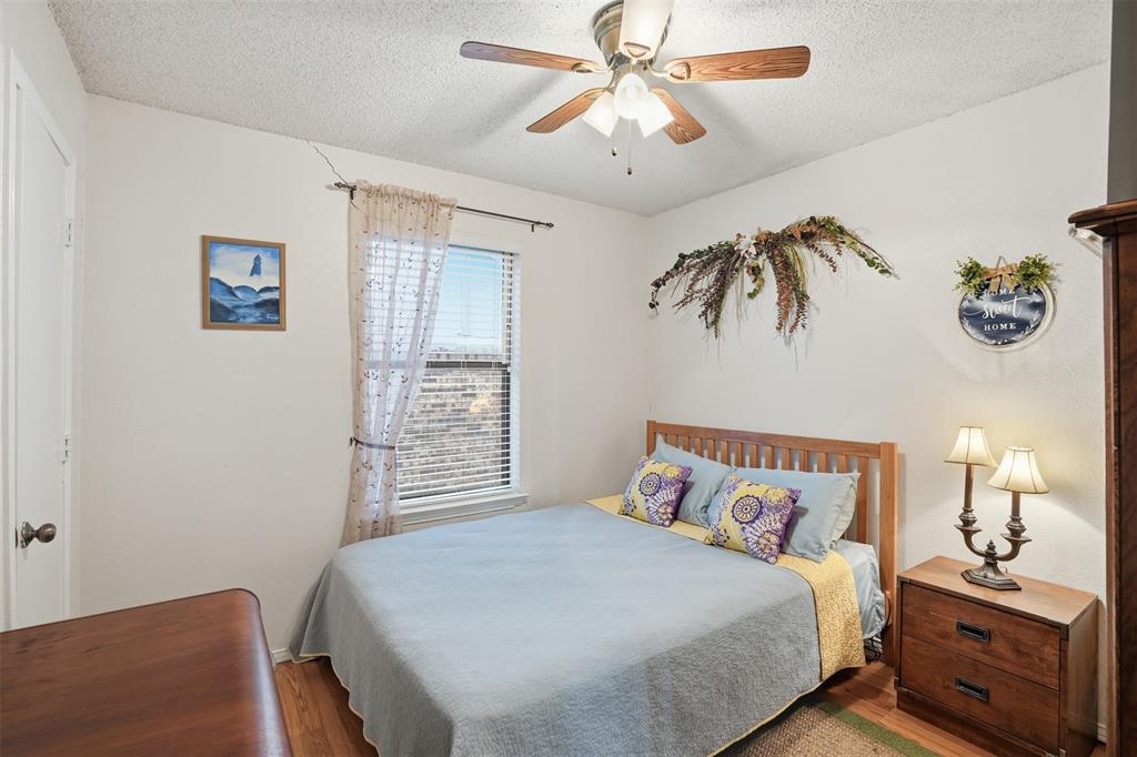 6437 High Lawn Terrace Watauga, TX 76148 - Photo 18 of 21 a bedroom with a bed and a chandelier