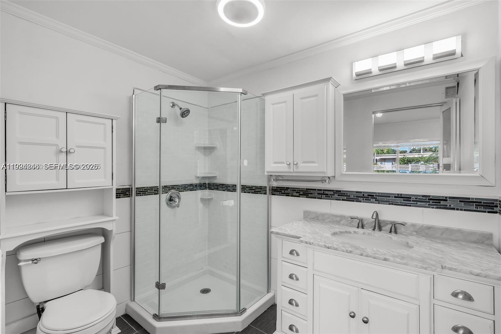 3800 Charles Terrace Miami, FL 33133 - Photo 6 of 16 a bathroom with a granite countertop sink mirror vanity and toilet