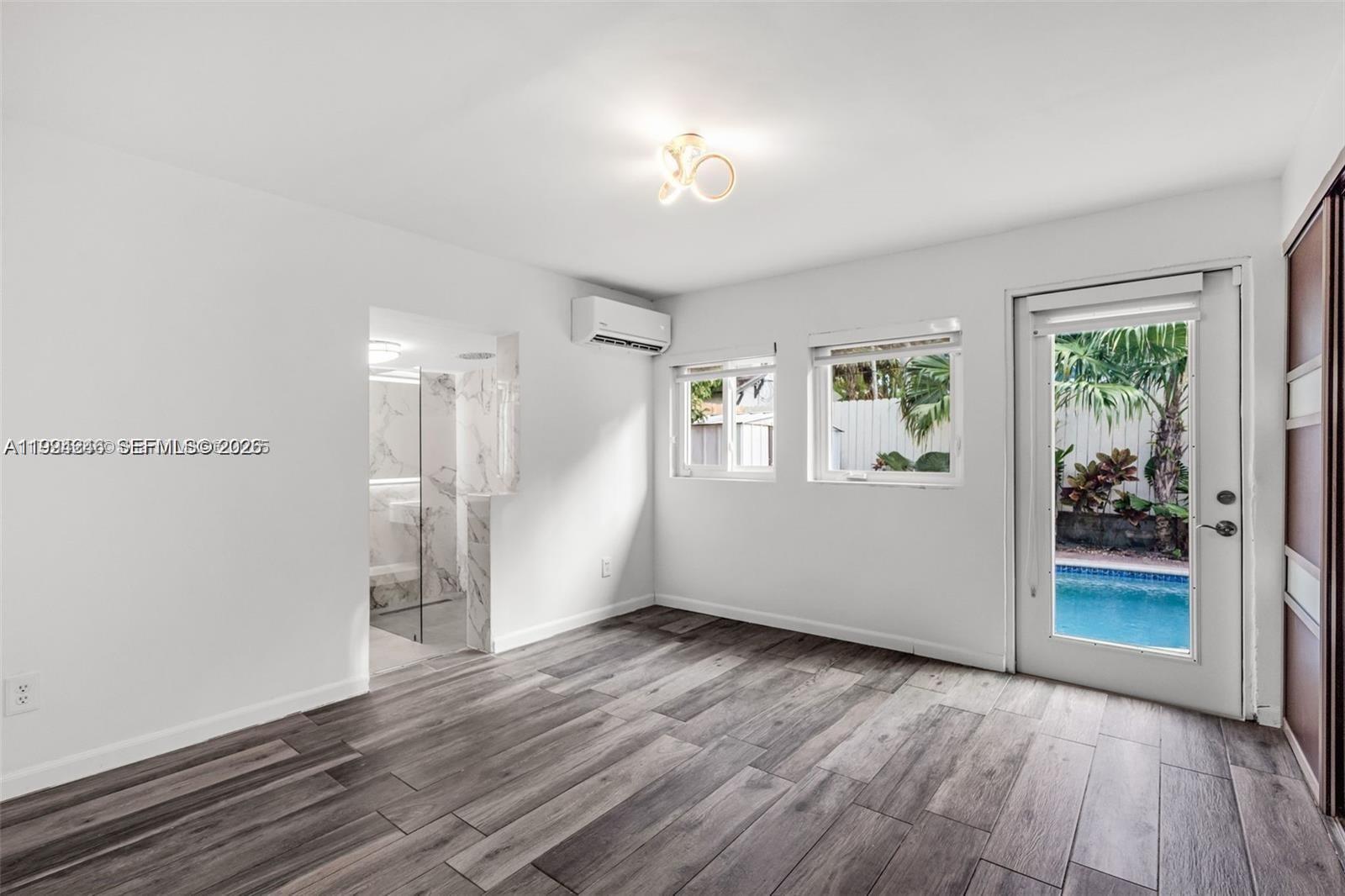 3800 Charles Terrace Miami, FL 33133 - Photo 9 of 16 an empty room with wooden floor and windows