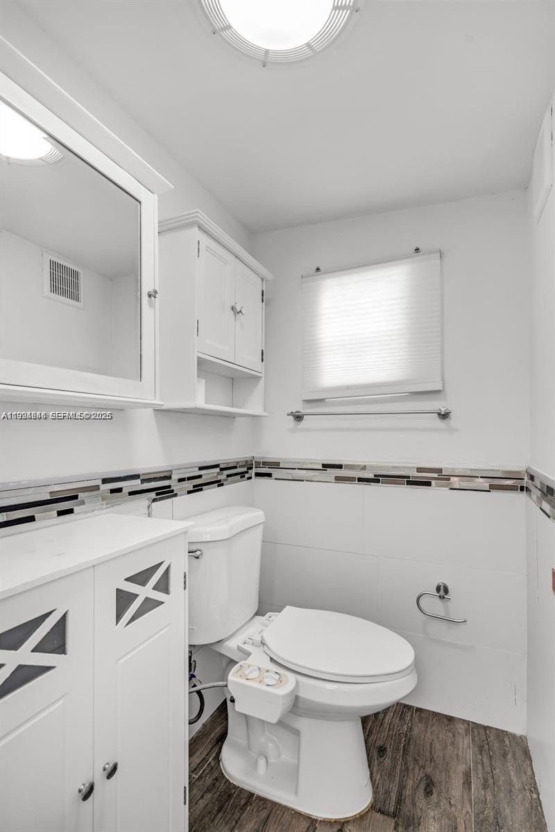 3800 Charles Terrace Miami, FL 33133 - Photo 10 of 16 a bathroom with a toilet a sink and a window