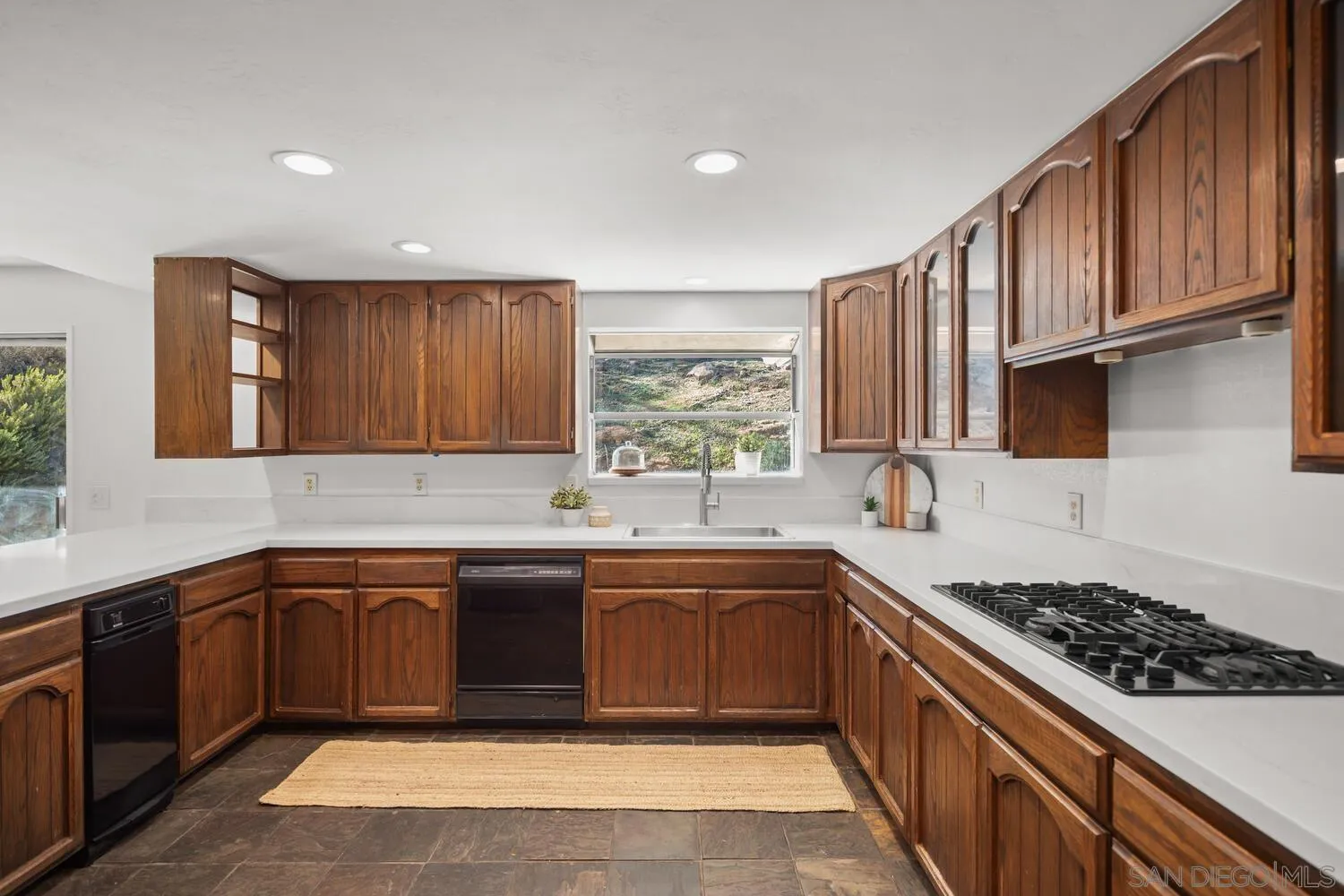 18435 Chablis Road Ramona, CA 92065 - Photo 12 of 49 a kitchen with stainless steel appliances granite countertop a sink stove and cabinets