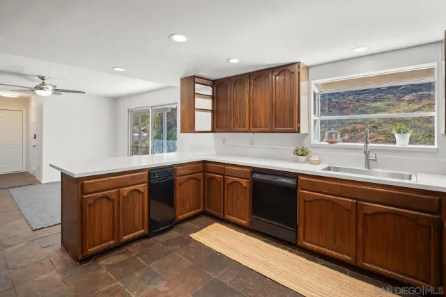 a kitchen with stainless steel appliances a refrigerator and a stove top oven