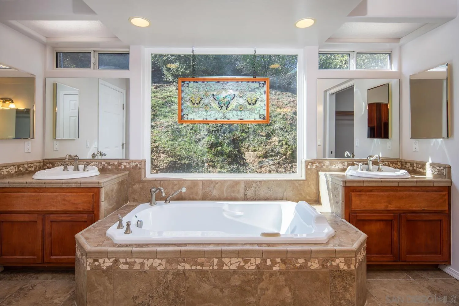 18435 Chablis Road Ramona, CA 92065 - Photo 18 of 49 a bath tub sitting in a bathroom next to a sink
