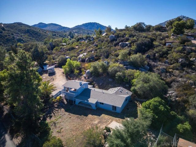 an aerial view of a house with mountain view