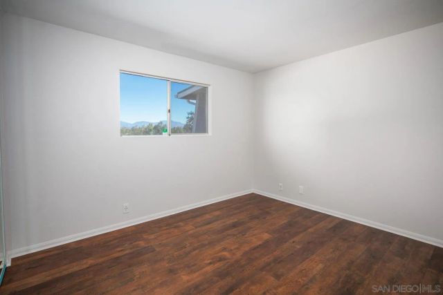 a view of a house with a yard and potted plants