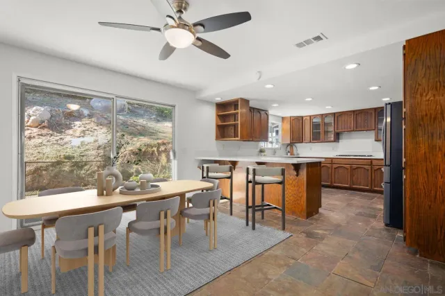 a kitchen with stainless steel appliances granite countertop a lot of counter space and a refrigerator